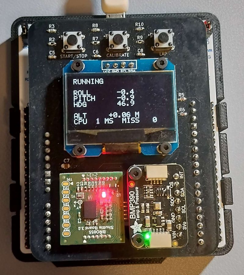 The estimator board running: the display reads out roll, pitch, heading and altitude beside the IMU and barometer breakouts